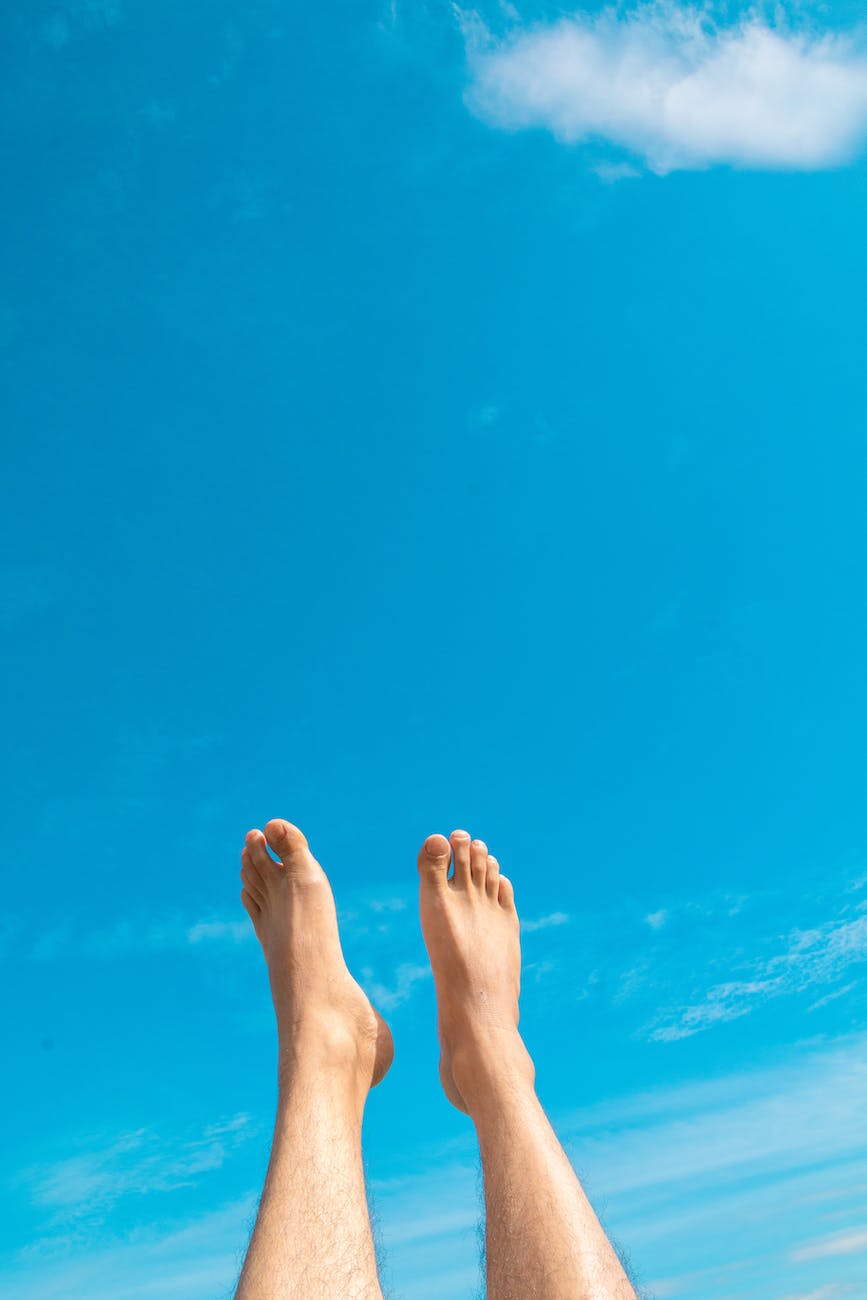 closeup photo of person s feet in the air