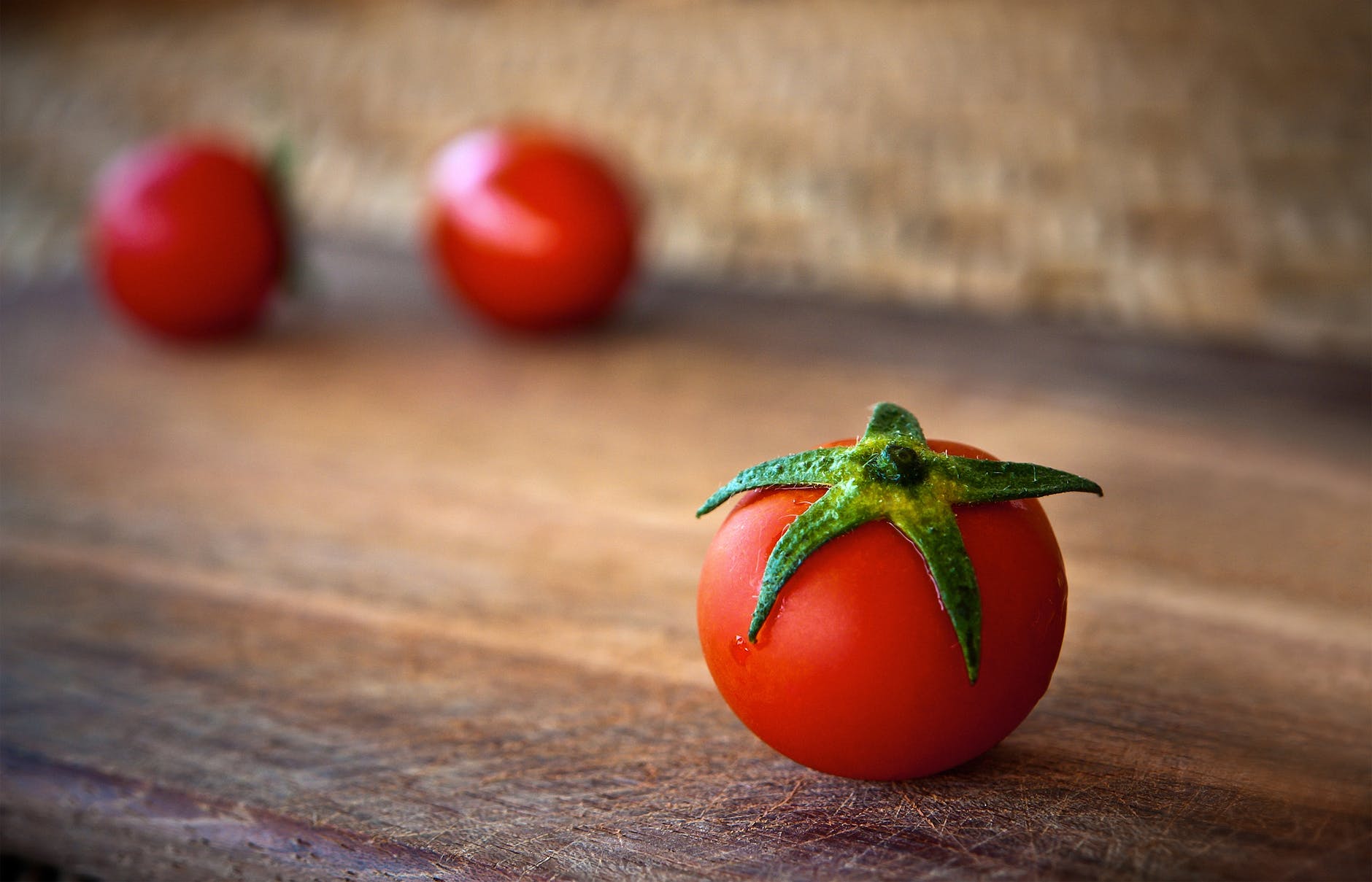 close up of tomatoes on wooden table