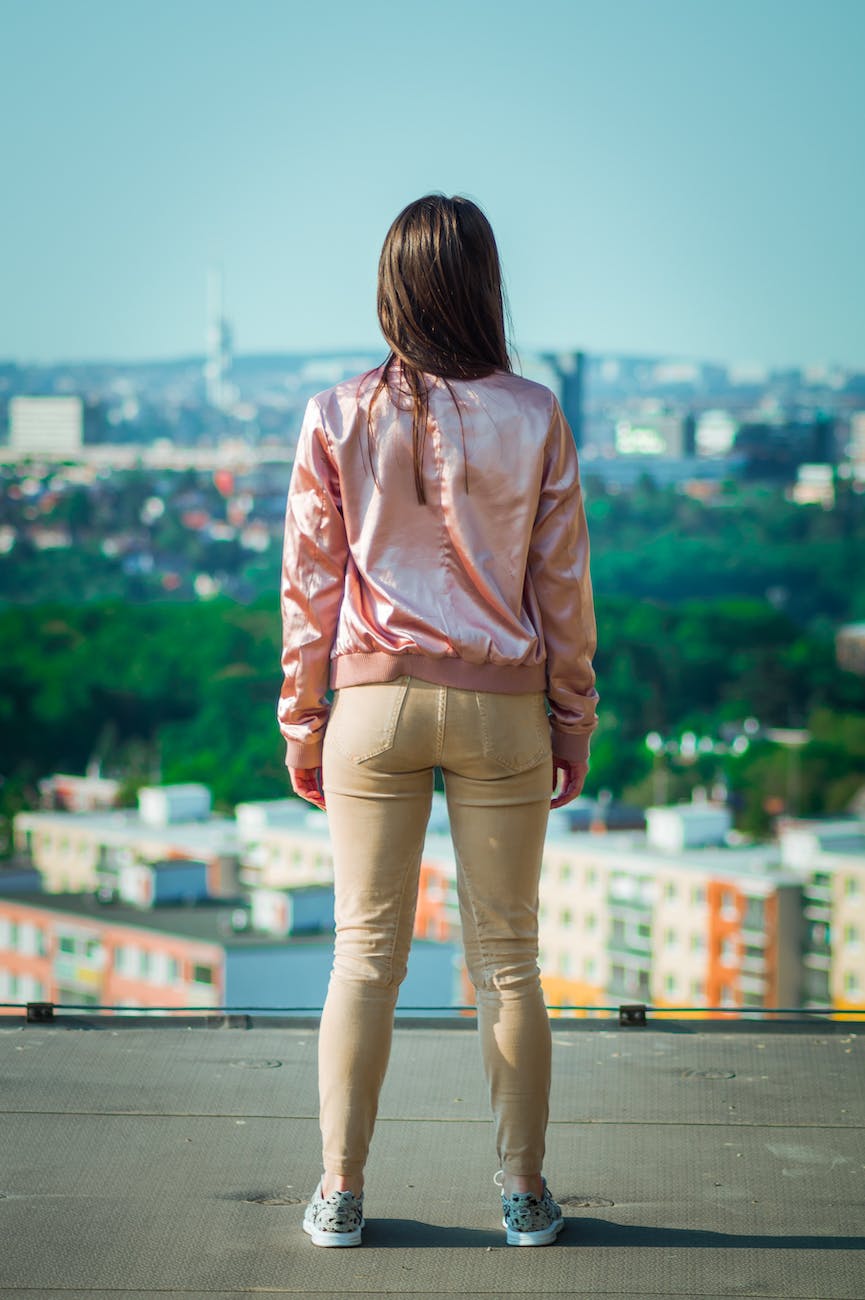 woman standing while wearing pink jacket
