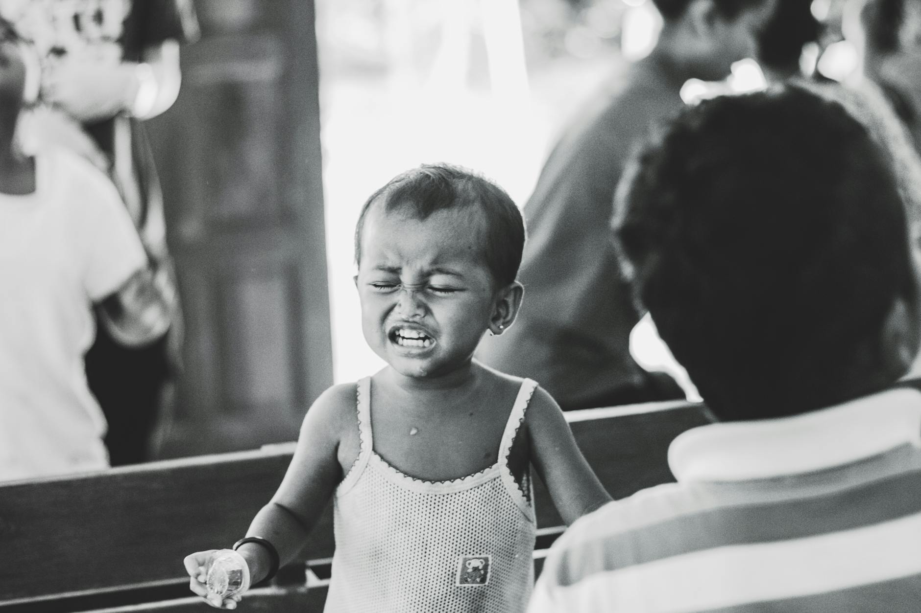 grayscale photography of child in spaghetti strap top