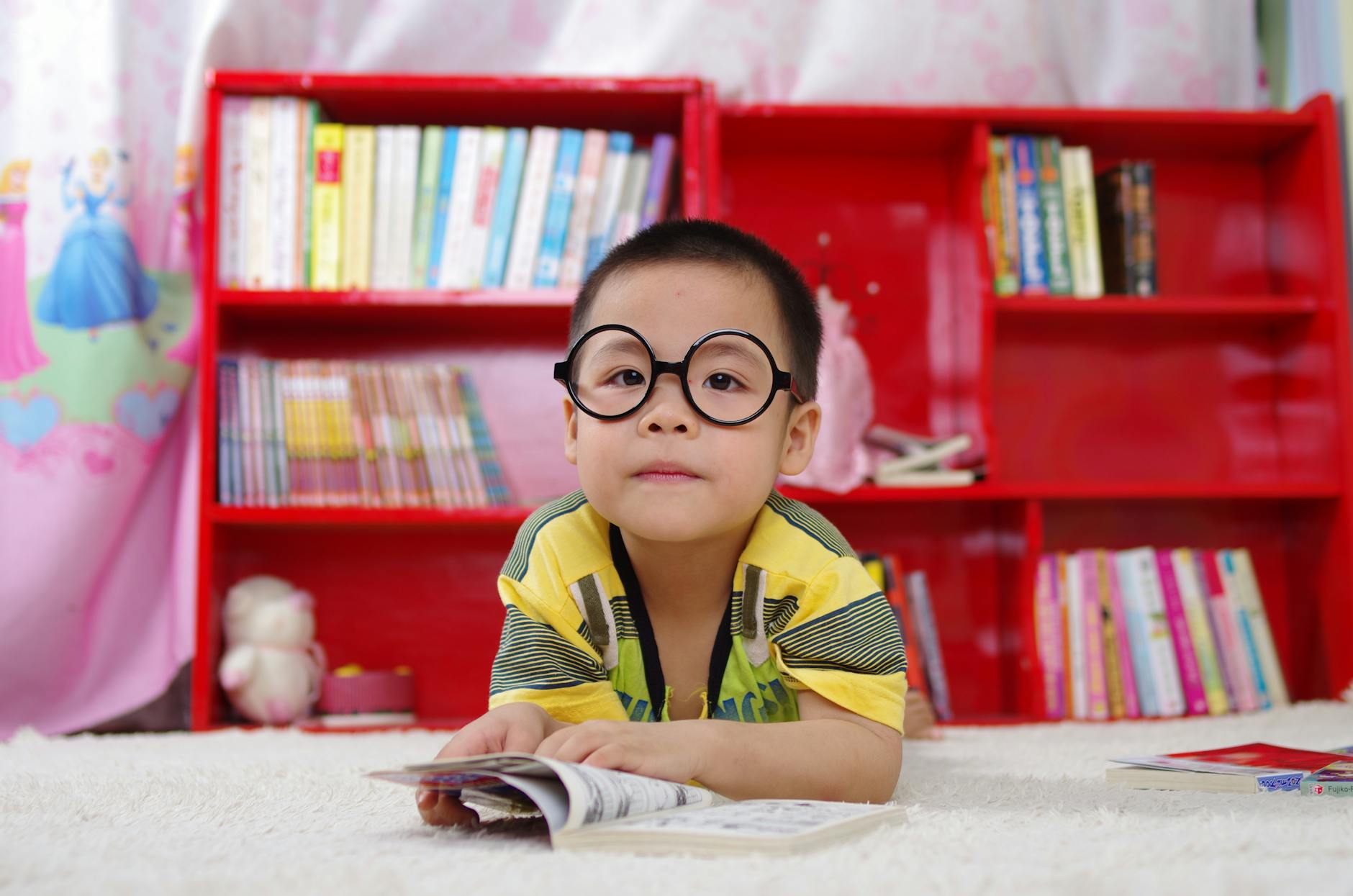 boy standing near bookshelf