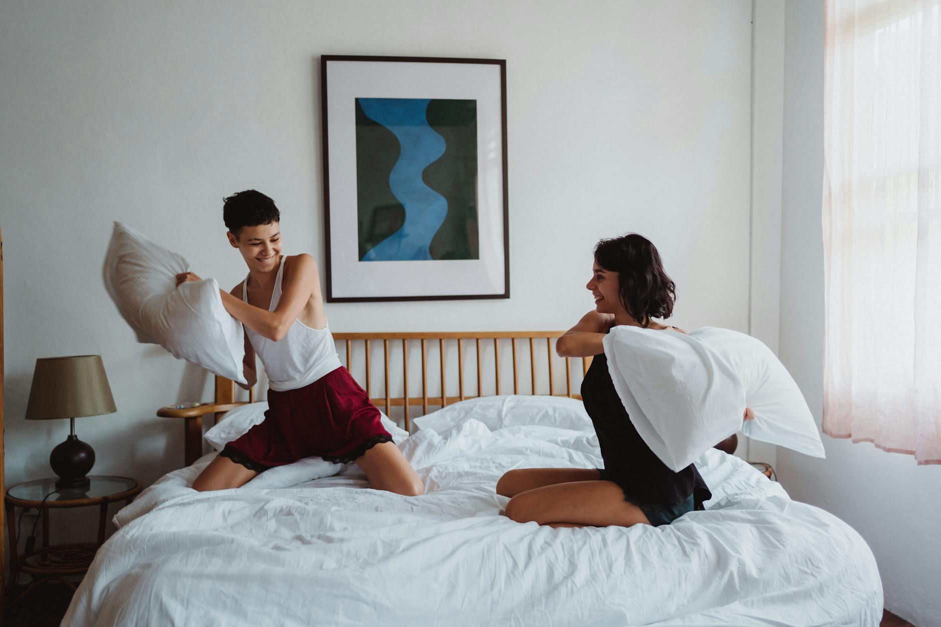 two women having a pillow fight