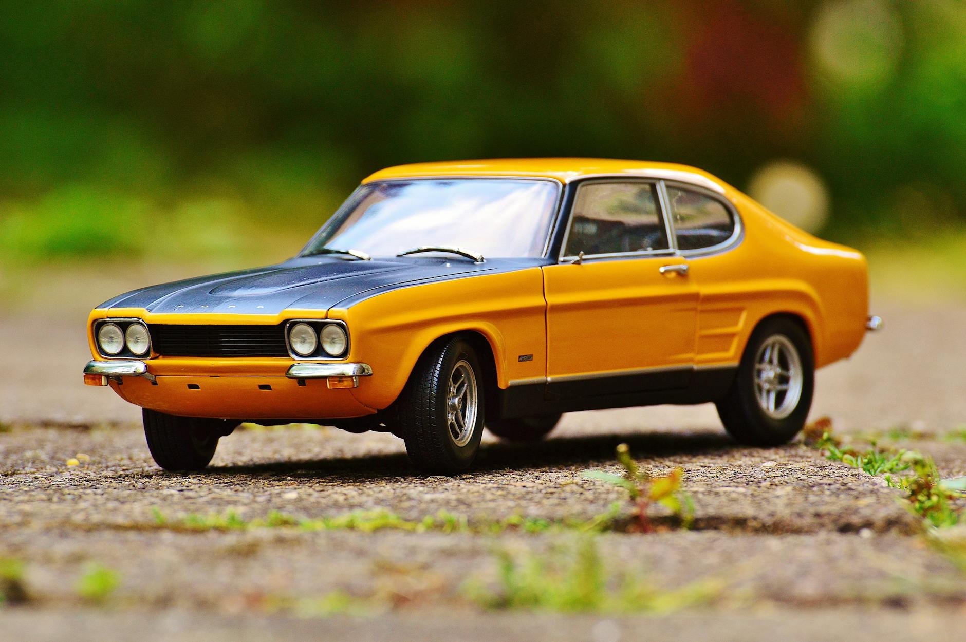 yellow and black muscle car in tilt shift photography