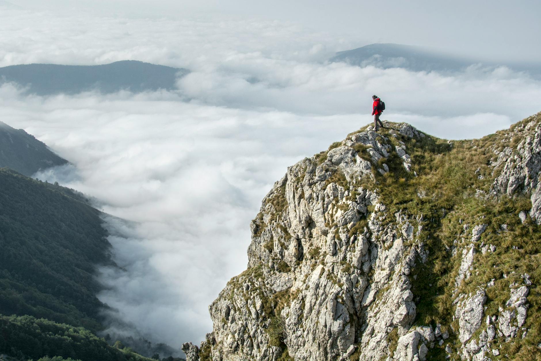 photography of person on green mountain