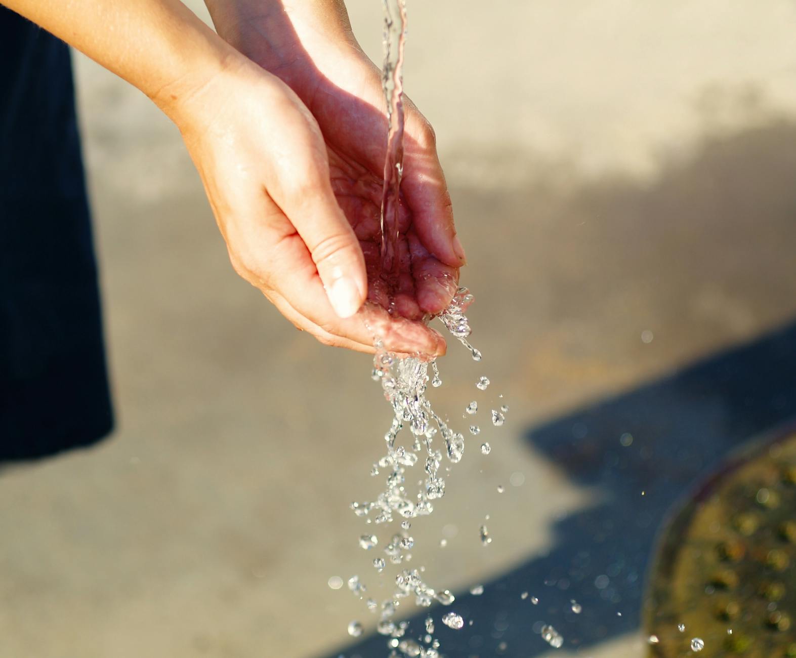 water pouring on person s hand