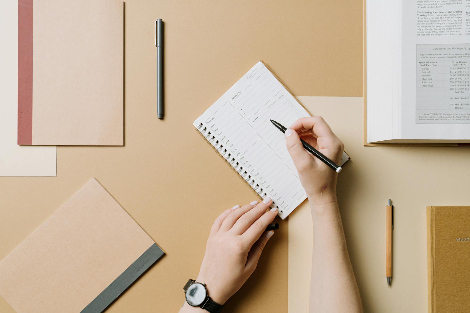 top view of woman writing in a planner