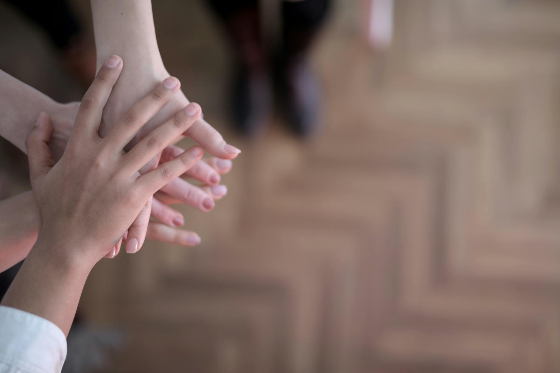 crop group stacking hands together