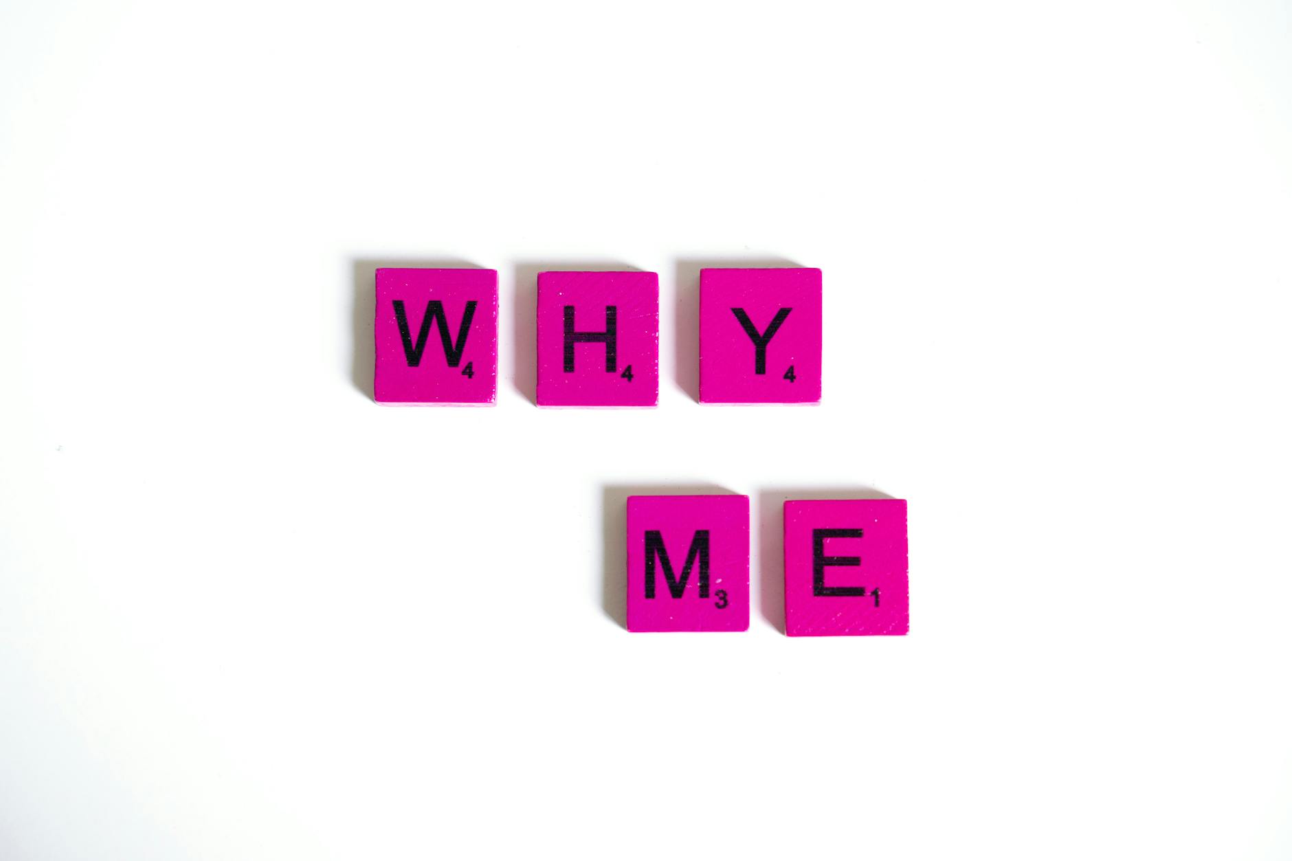 pink scrabble tiles on white background