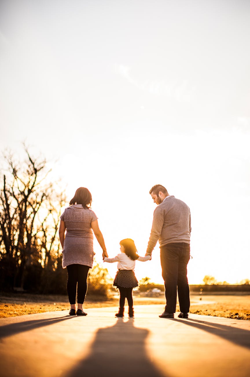 photo of family standing outdoors during golden hour