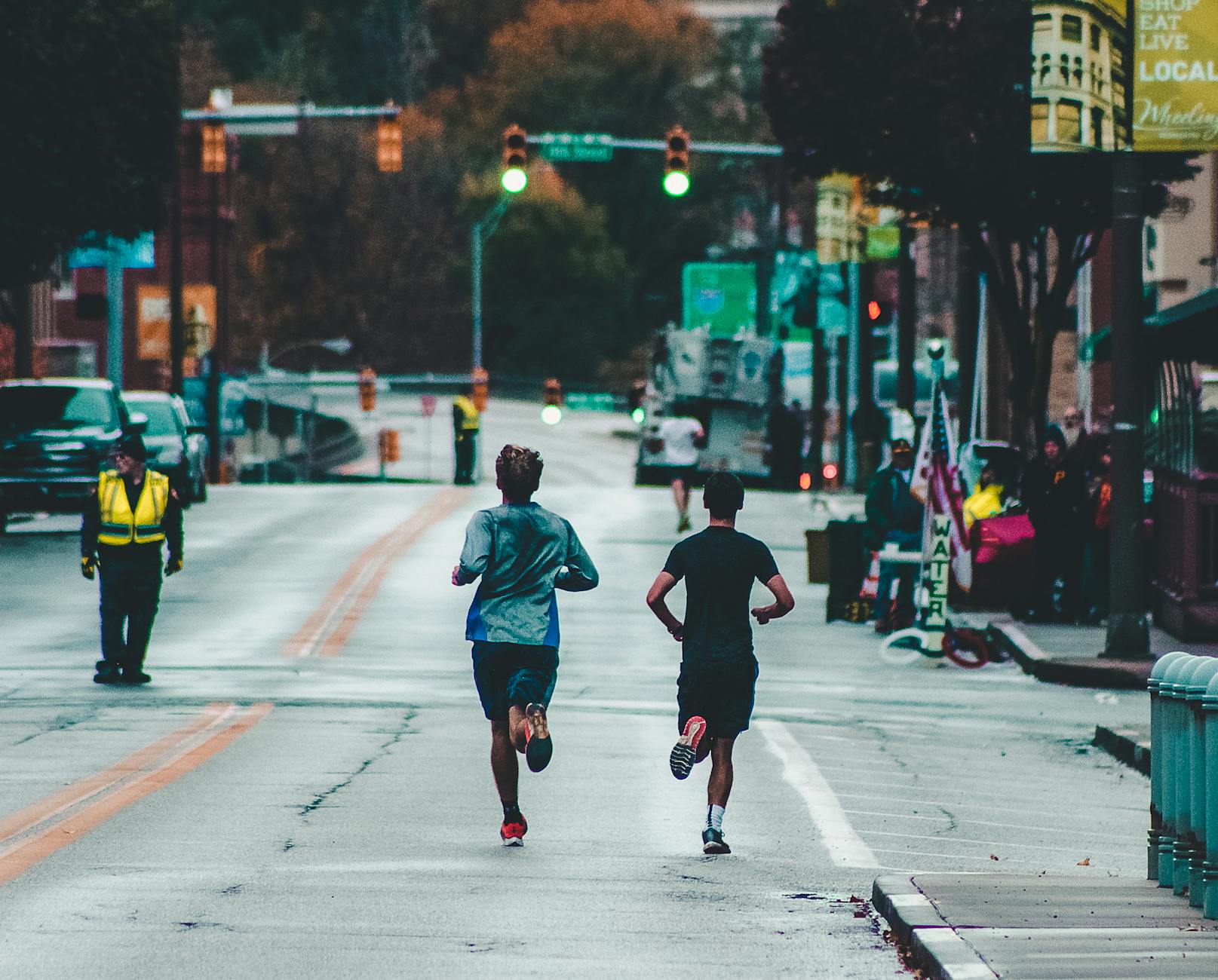 two men running on concrete road