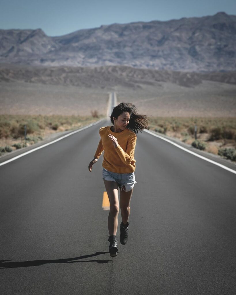 photo of woman running on road