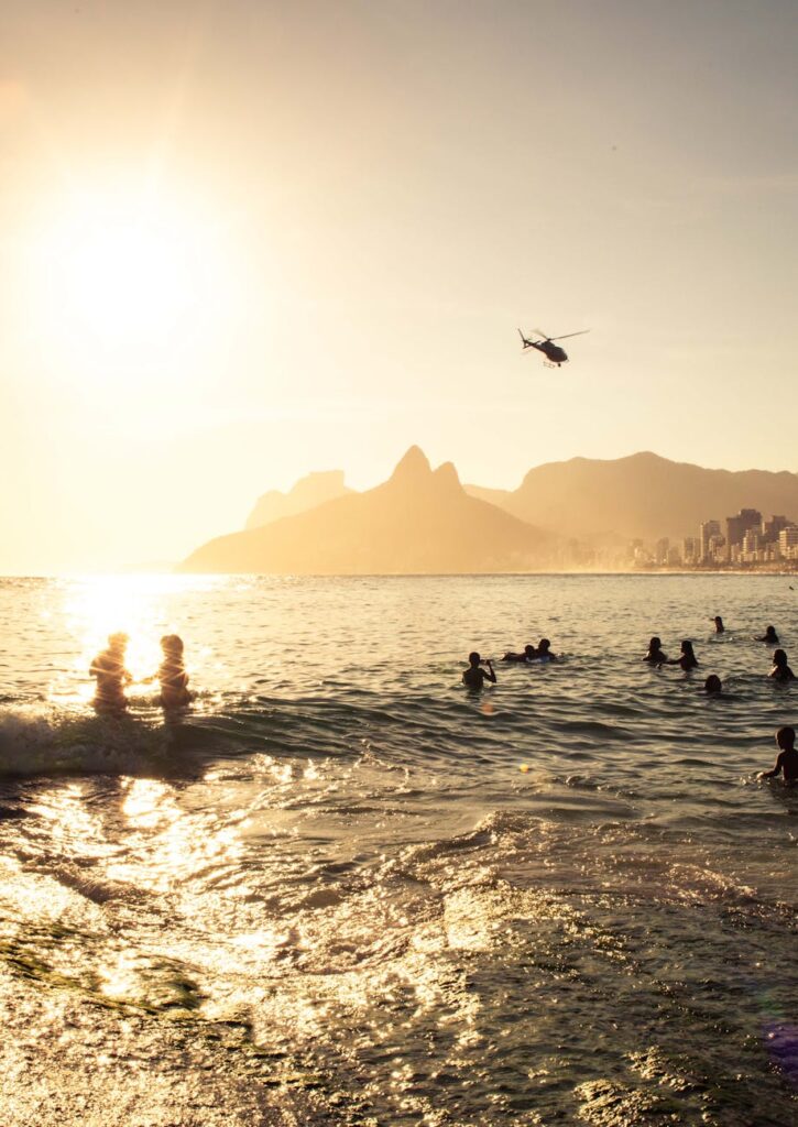 sunset beach at ipanema with swimmers