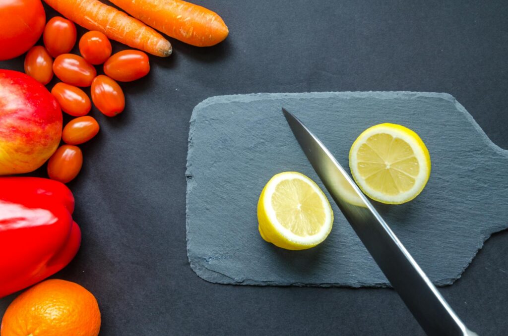 sliced lemon on gray chopping board