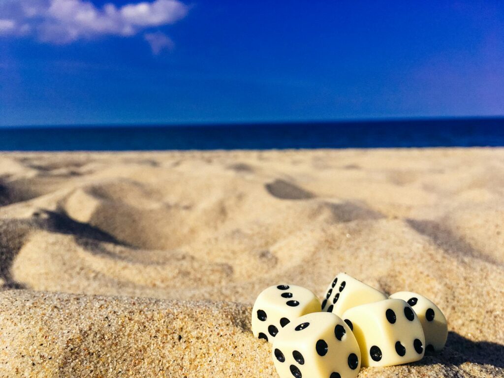 five dice on sand