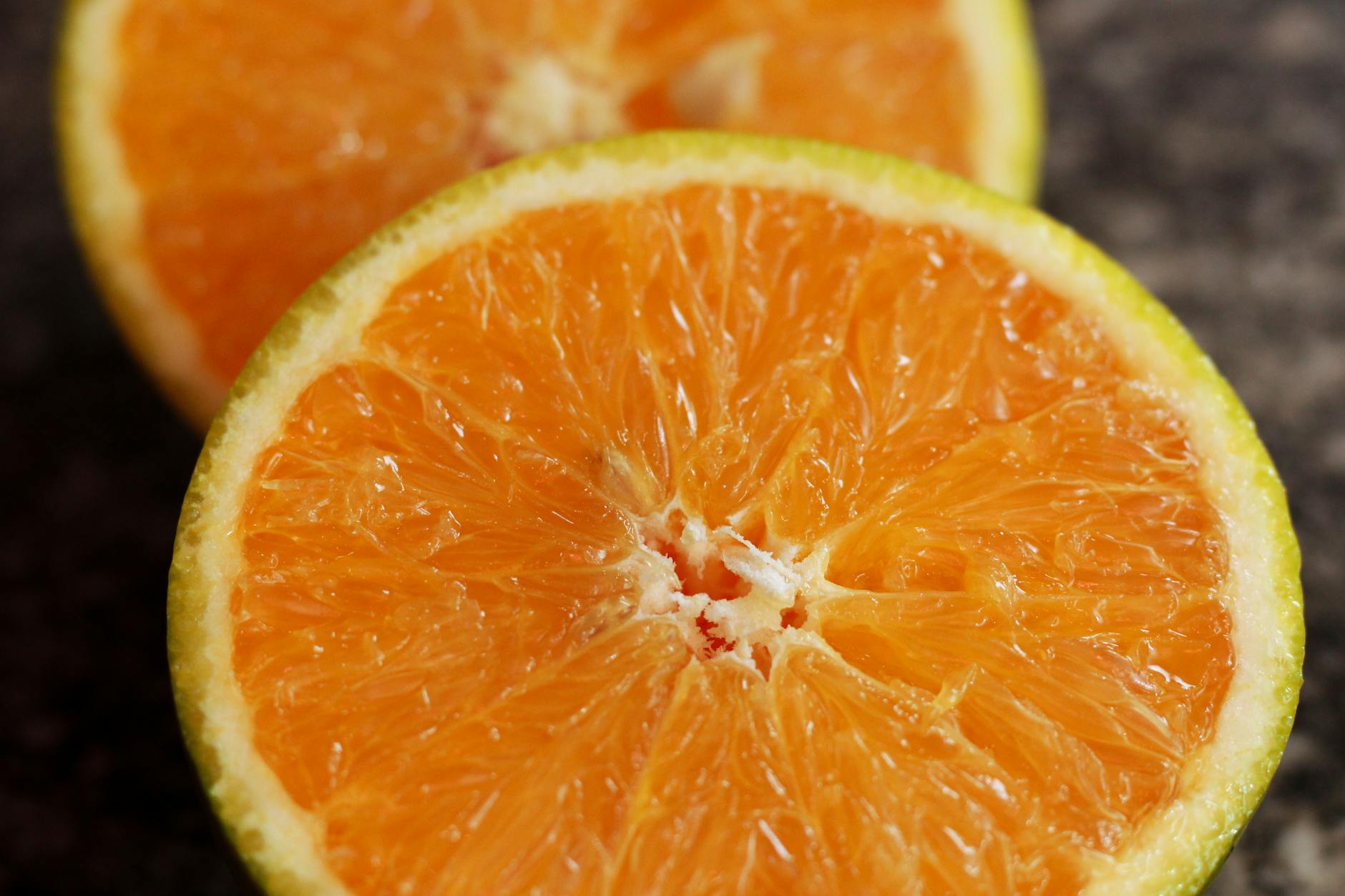 close up of fresh sliced oranges on dark background