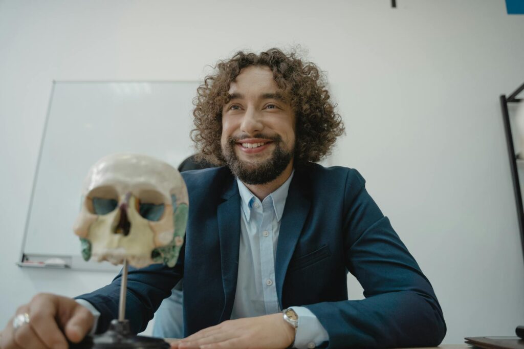 a bearded man teaching biology in a class