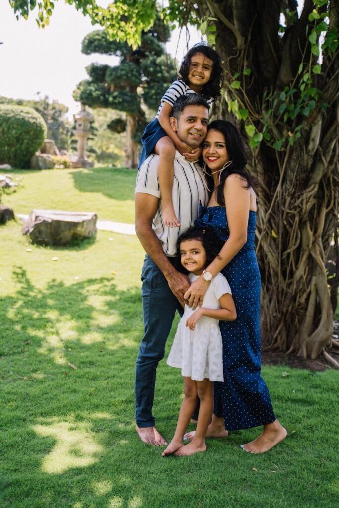 happy family standing on green grass