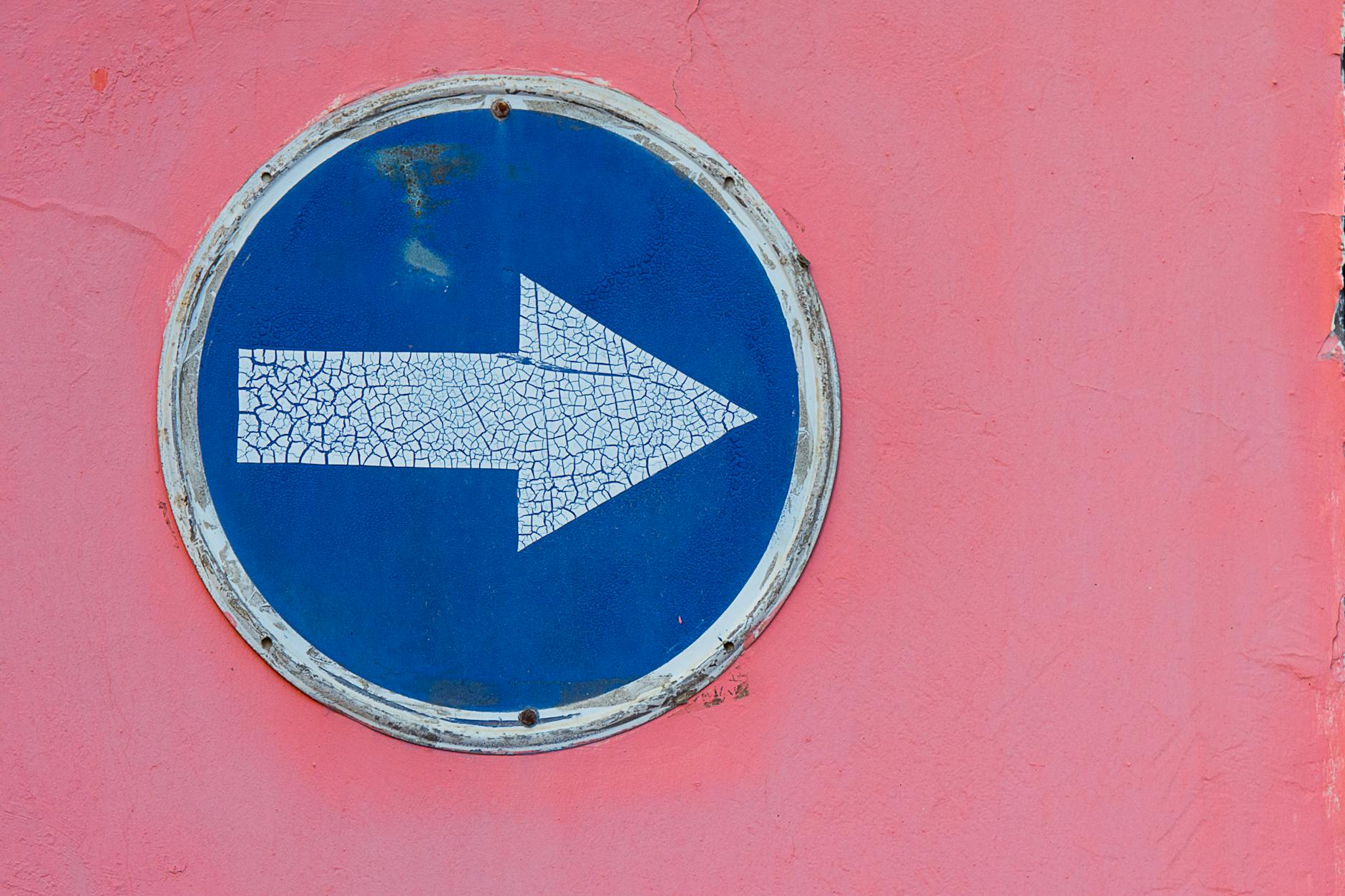 an arrow signage on the wall