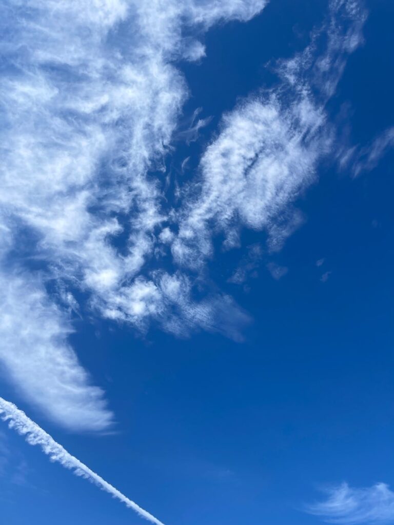 vibrant blue sky with wispy white clouds