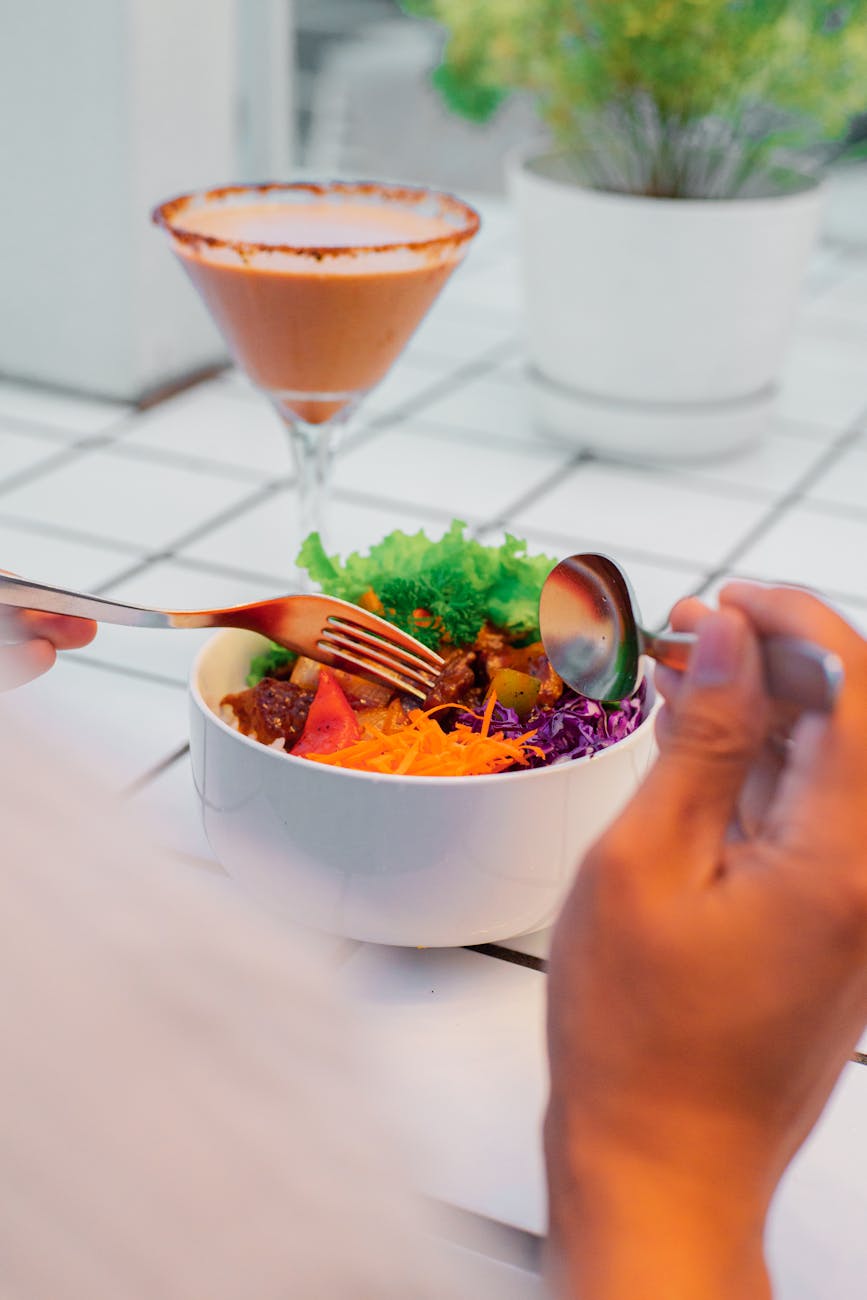 vibrant salad bowl with chocolate drink in cafe