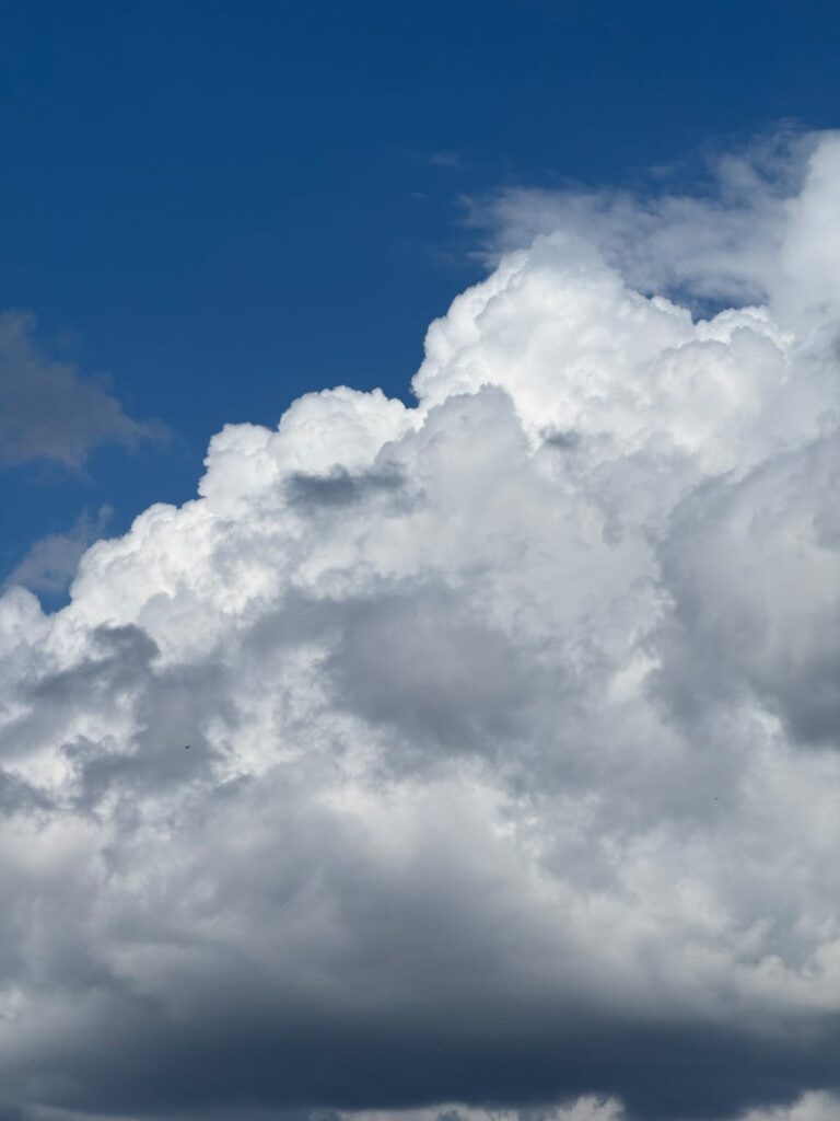 dramatic cumulonimbus clouds against blue sky