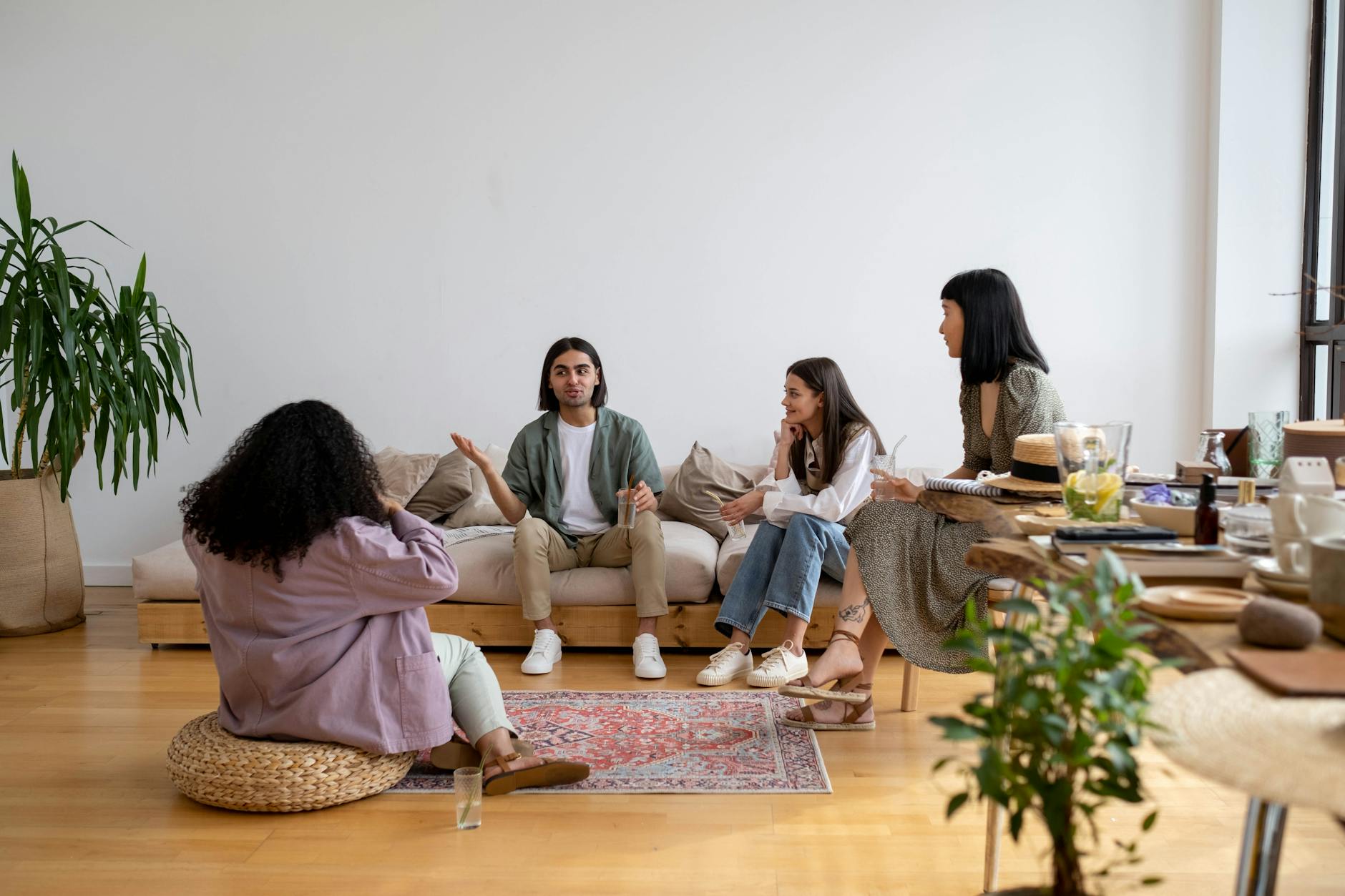 people sitting on the living room talking