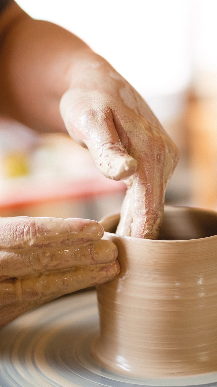 person making clay pot