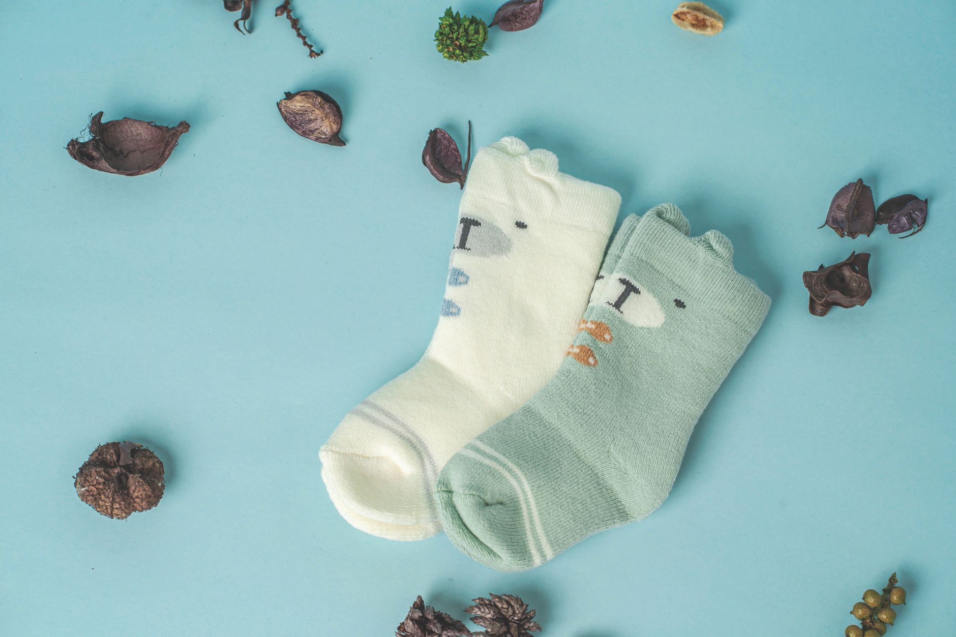 close up shot of baby socks on blue surface
