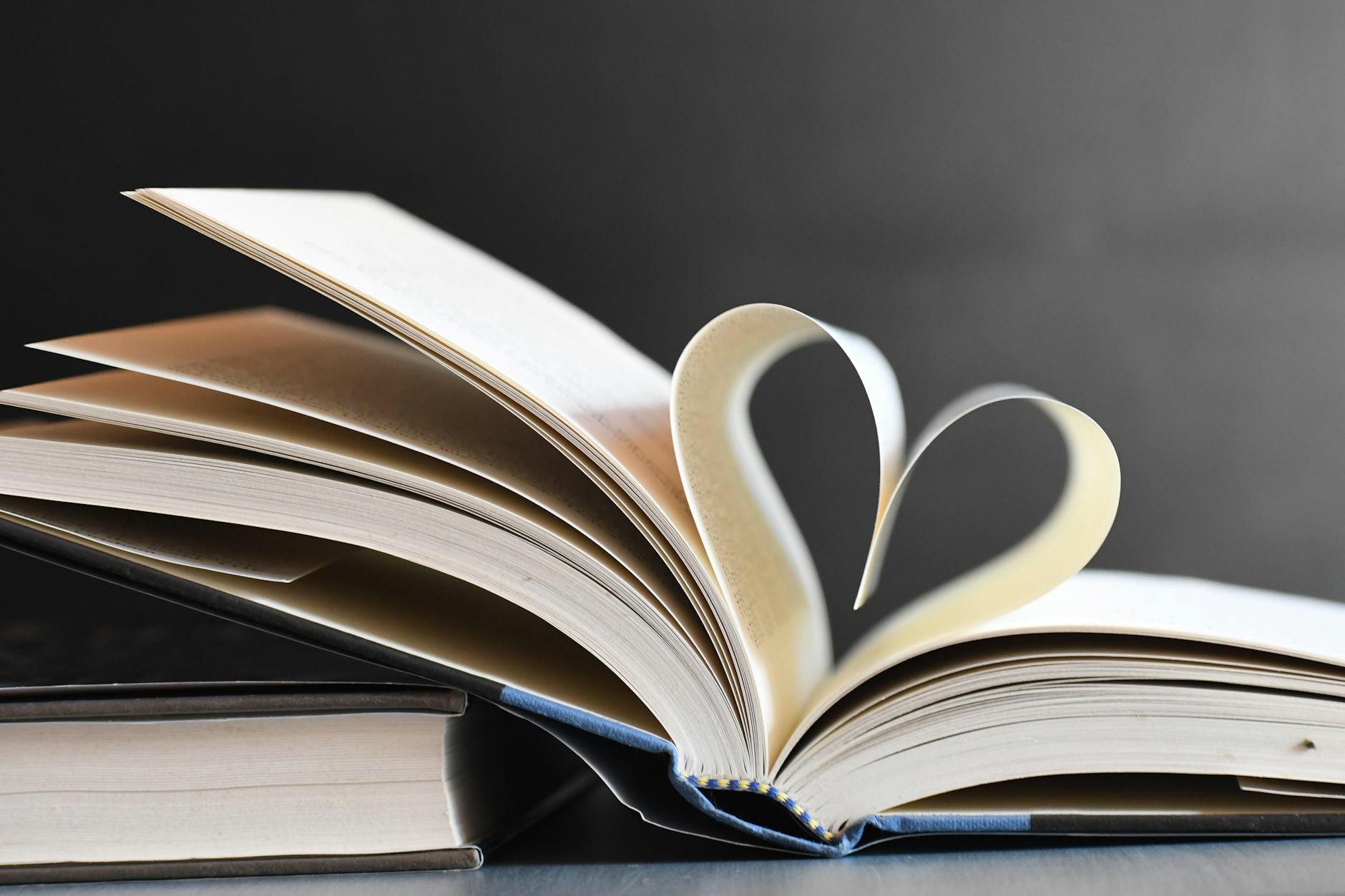 open book with heart shaped pages in focus