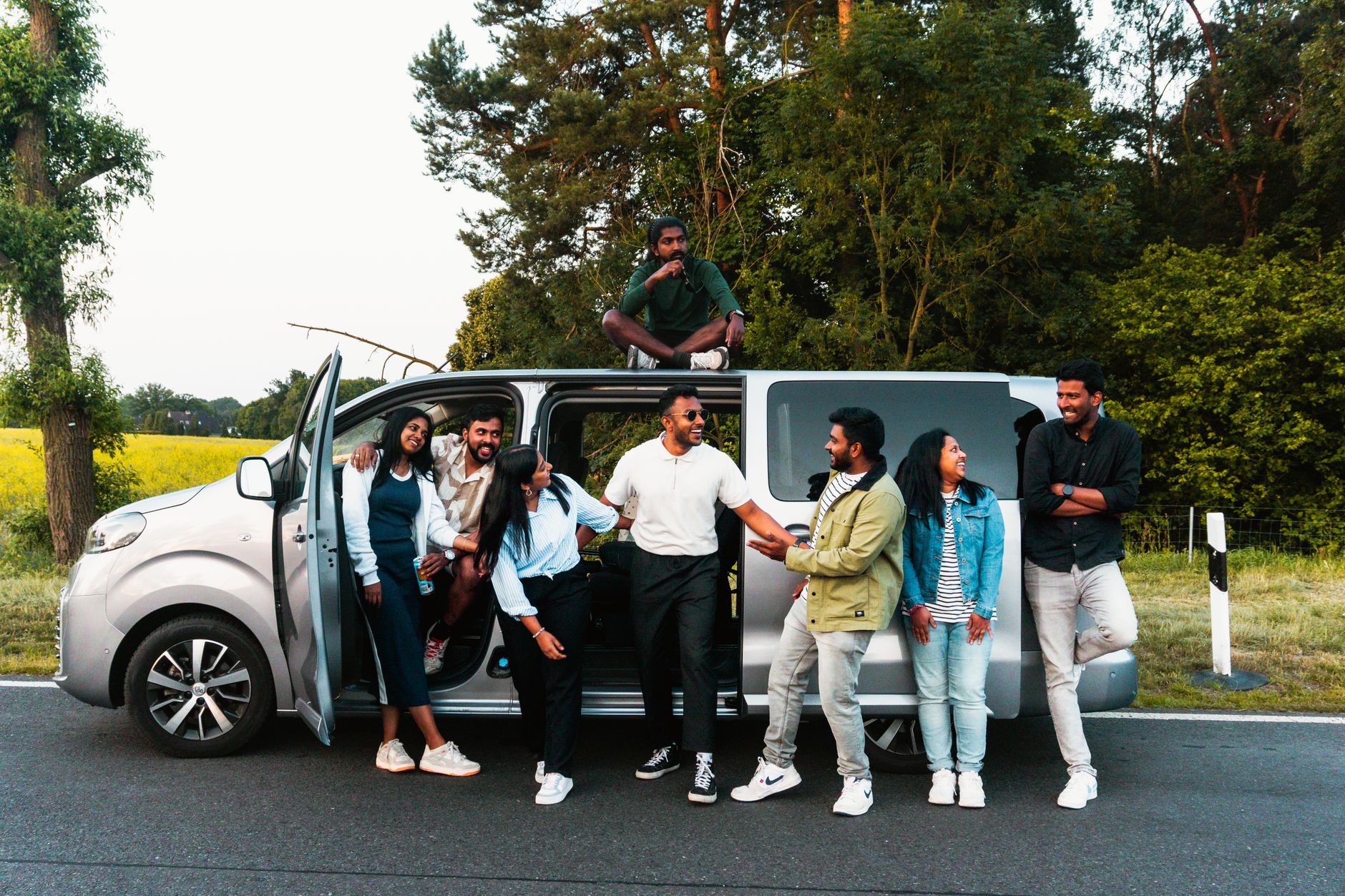 group of friends enjoying a road trip outdoors