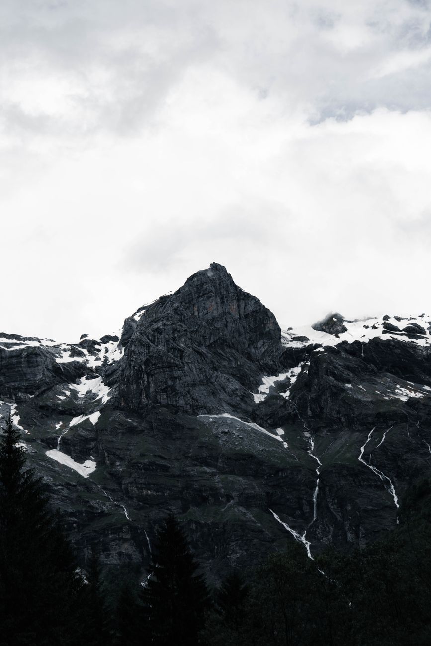barren mountains peaks under cloud